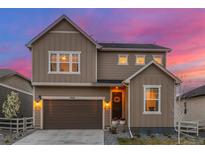 Charming two-story home with a well-maintained yard and a brown two car garage at 4925 Coltin Trl, Castle Rock, CO 80104