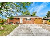 Charming brick home with well-maintained lawn and a large concrete driveway at 7940 Appleblossom Ln, Westminster, CO 80030