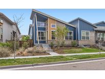 Striking modern home with a well-maintained front yard and unique architectural details at 9422 E 58Th Pl, Denver, CO 80238