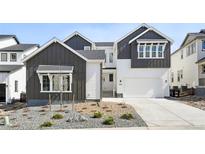 Two-story home featuring gray and white color scheme, landscaped front yard, and attached two-car garage at 3378 Backdrop Ct, Castle Rock, CO 80108