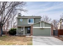 Charming two-story home with attached two-car garage and a well-maintained front yard at 6306 Xavier St, Arvada, CO 80003
