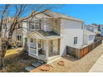 Charming two-story home with a cozy front porch and professionally maintained landscaping at 10700 Kimblewyck Cir # 201, Northglenn, CO 80233