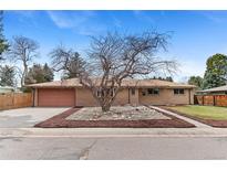 Charming single story home boasts a well maintained lawn, brick exterior, and attached garage at 6161 S Southwood Dr, Centennial, CO 80121
