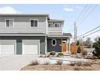 Charming two-story home with a two-car garage and beautifully landscaped front yard at 3402 N Clayton St, Denver, CO 80205
