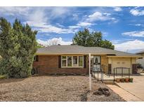 Charming brick single-story home featuring a well-maintained lawn, covered entryway, and attached garage at 2692 S Osceola St, Denver, CO 80219