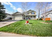 Charming two-story home with a well-maintained lawn and inviting front porch at 3865 Rawhide Cir, Castle Rock, CO 80104
