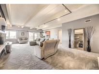 Spacious living room featuring recessed lighting, neutral tones, and balcony access at 7865 E Mississippi Ave # 602, Denver, CO 80247