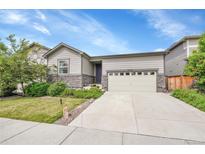Charming one-story home with a well-manicured lawn and inviting front entrance and two-car garage at 9635 Bellaire Ln, Thornton, CO 80229