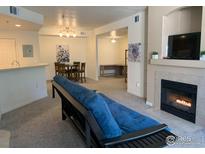 Inviting living room featuring a fireplace, dining area, and neutral color palette at 560 Mohawk Dr # 35, Boulder, CO 80303