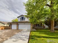 Charming two-story home featuring a two-car garage and a well-manicured front yard at 2720 E 121St Pl, Thornton, CO 80241