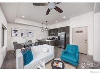 Bright living room features modern furnishings and an open floorplan connecting to the kitchen and dining area at 2445 Junction Pl # 206, Boulder, CO 80301
