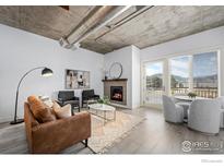 Spacious living room with fireplace and modern furniture at 3401 Arapahoe Ave # 218, Boulder, CO 80303