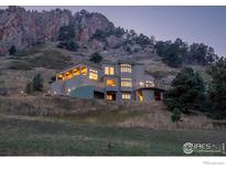 Stunning mountain home boasts scenic views and unique architectural design on a hillside at 230 S Cedar Brook Rd, Boulder, CO 80304