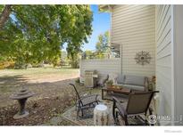 Inviting patio area featuring comfortable seating and a grill, perfect for outdoor entertaining and relaxation at 1226 Atwood St, Longmont, CO 80501