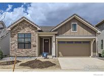 Charming single-Gathering home with stone accents and a well-manicured front yard under a cloudy sky at 3015 Newfound Lake Rd, Berthoud, CO 80513