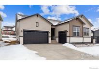 Ranch style home with 2-car garage and snow-covered driveway at 16850 Mckay Dr, Mead, CO 80542