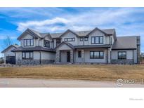 Striking two-story home boasts stone accents, a tile roof, and a well-manicured lawn, creating an inviting curb appeal at 9258 Niwot Hills Dr, Niwot, CO 80503