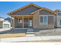 Charming single-Gathering home with stone accents and a covered front porch at 2263 Serenidad St, Brighton, CO 80601