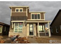 Two-story home with neutral siding and a covered porch at 2271 Serenidad St, Brighton, CO 80601