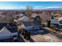 Aerial view of a house and surrounding neighborhood, mountain views at 3557 Settler Ridge Dr, Mead, CO 80542