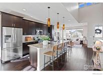 Modern kitchen with stainless steel appliances and an island at 4692 Clear Creek Dr, Firestone, CO 80504