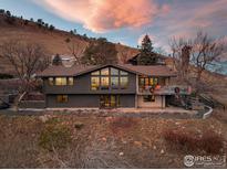 Stunning aerial view of a contemporary home nestled in the hills, showcasing its unique architecture and landscape at 230 Cactus Ct, Boulder, CO 80304