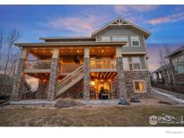 Two-story home with stone accents and a large deck at 7690 S Blackstone Pkwy, Aurora, CO 80016