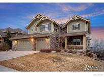 Inviting two-story home with a three-car garage, stone accents, and a cozy front porch at 7690 S Blackstone Pkwy, Aurora, CO 80016