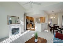 Bright living room with fireplace and view into kitchen at 10710 Eliot Cir # 101, Westminster, CO 80234