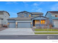 Two-story home with attached garage and landscaped front yard at 1860 Miranda Rd, Erie, CO 80516