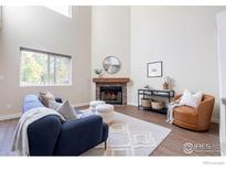 Bright living room features a fireplace and comfortable seating at 6158 Habitat Dr, Boulder, CO 80301