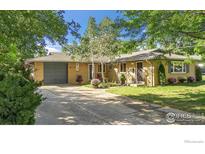 Ranch style home with a well-maintained lawn and attached garage at 1950 Glenwood Dr, Boulder, CO 80304