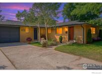 Charming single-story brick home featuring a well-manicured lawn and inviting front entrance at 1950 Glenwood Dr, Boulder, CO 80304