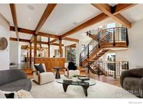 Open living room with high ceilings, exposed beams, and a stunning view at 2088 Alpine Dr, Boulder, CO 80304