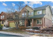 Two-story house with green and brick exterior, landscaping, and driveway at 2734 W 119Th Ave, Westminster, CO 80234