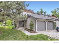 Attractive exterior of a two-story townhome with a two-car garage and well-manicured lawn at 4648 Chestnut Ln, Boulder, CO 80301