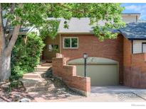 Brick front exterior of charming home with attached garage and landscaping at 4961 Sundance Sq, Boulder, CO 80301