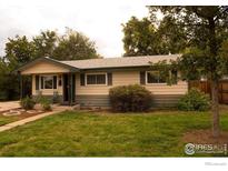 Charming ranch home with a spacious front yard at 6213 Gray St, Arvada, CO 80003