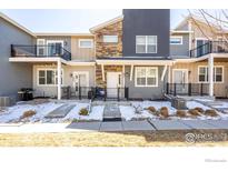 Contemporary townhome showcasing mixed materials, personal patios, and well-maintained landscaping at 821 Robert St, Longmont, CO 80503