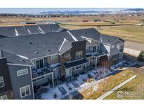 Newer townhomes in a community setting, featuring modern architecture, landscaping, and mountain views at 821 Robert St, Longmont, CO 80503