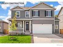 Two-story home with gray siding, white trim, and a two-car garage at 6536 12Th St, Frederick, CO 80530