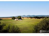 Aerial view of property showcasing expansive land and distant mountain views at 6789 Niwot Rd, Longmont, CO 80503