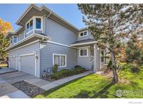 Gray two-story home with attached two-car garage and landscaping at 140 Sugar Plum Way, Castle Rock, CO 80104