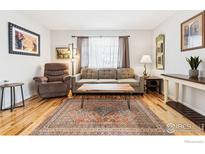 Cozy living room featuring hardwood floors, comfortable seating, and a stylish coffee table at 1400 Bacchus Dr # C11, Lafayette, CO 80026