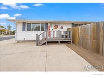 Charming single-story home featuring a welcoming porch, white siding, and a well-maintained front yard at 1502 Carmelita Ct, Platteville, CO 80651