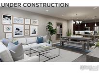 Open living room featuring sectional sofa, coffee table, and gallery wall at 410 High Point Dr # 104, Longmont, CO 80504