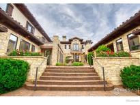Elegant courtyard entry with fountain and stonework at 6851 Goldbranch Dr, Niwot, CO 80503