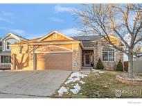 Brick house with a two-car garage and landscaped yard at 859 Topaz St, Superior, CO 80027