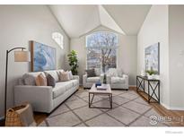 Spacious living room with vaulted ceilings and hardwood floors at 859 Topaz St, Superior, CO 80027