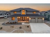 Two-story house with a large window and attached two-car garage at 944 Saint Andrews Ln, Louisville, CO 80027